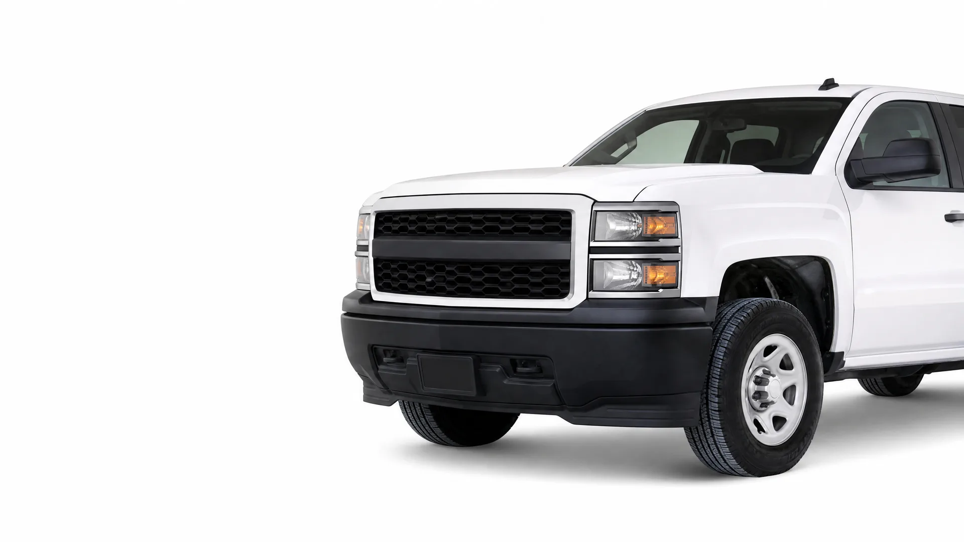 Front three-quarter view of a white pickup truck with a black grille and bumper, cropped at the cab, on a plain white background with a soft shadow.