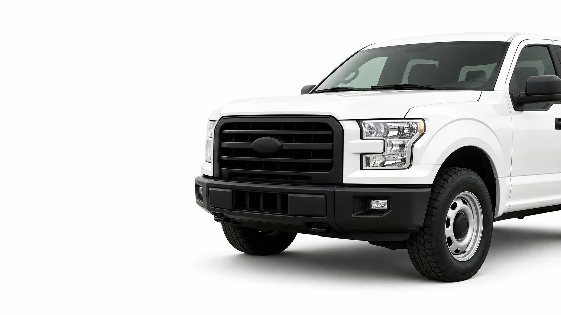 Front half of a white pickup truck with a black grille, black bumper and steel wheels, shown against a plain white background.