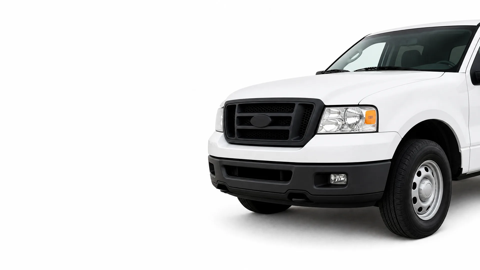 Front half of a white pickup truck with a black grille and bumper, photographed against a plain white background.