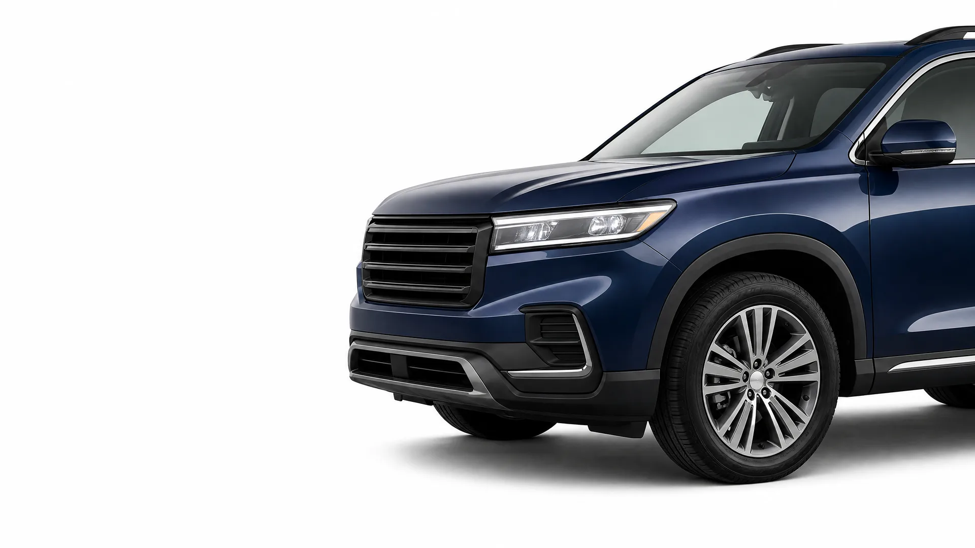 Front three-quarter view of a dark blue SUV on a plain white background, showing the grille, headlight, front wheel and driver-side doors.