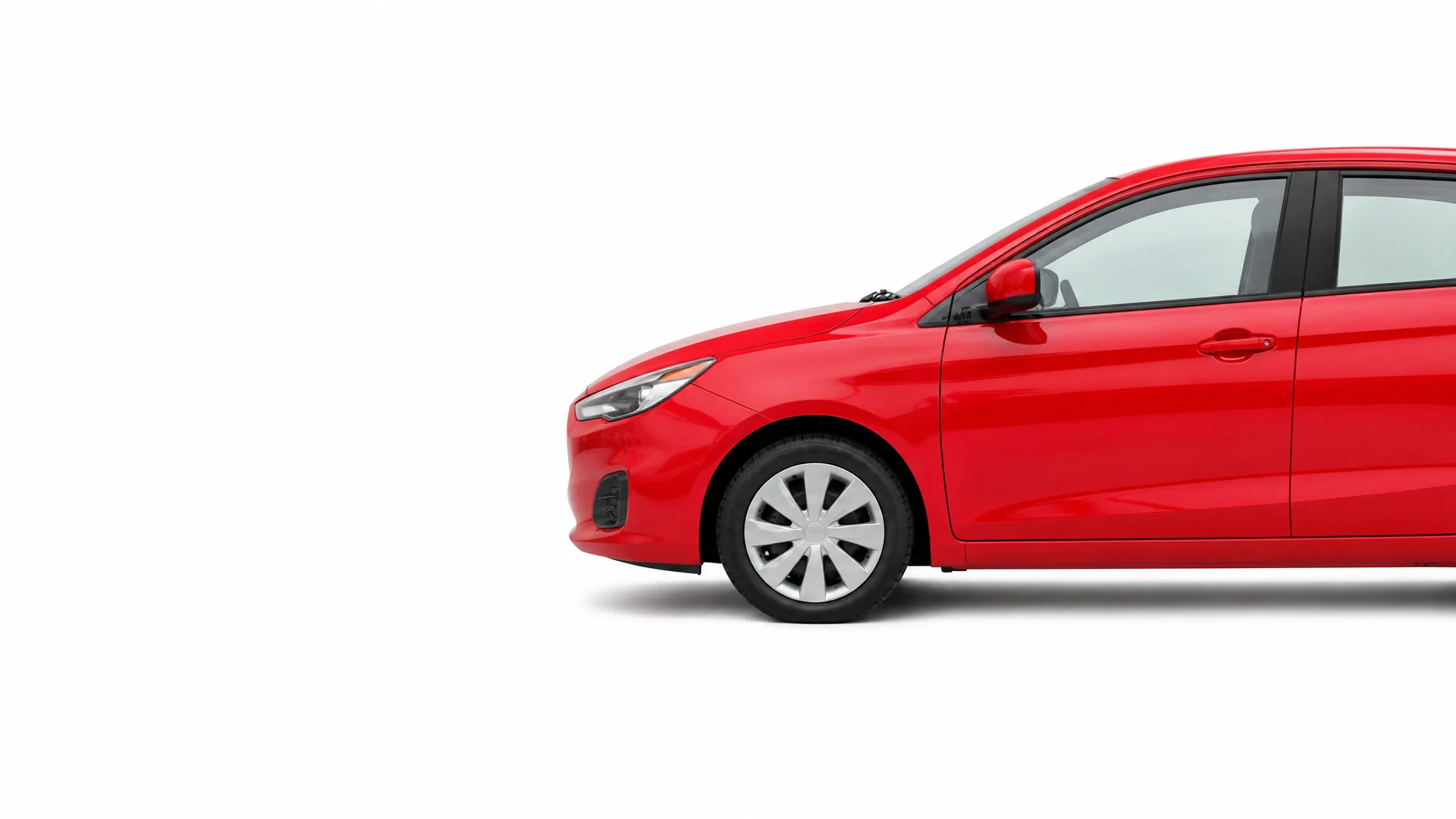Front half of a red four-door car shown in side profile against a plain white background, cropped at the rear.