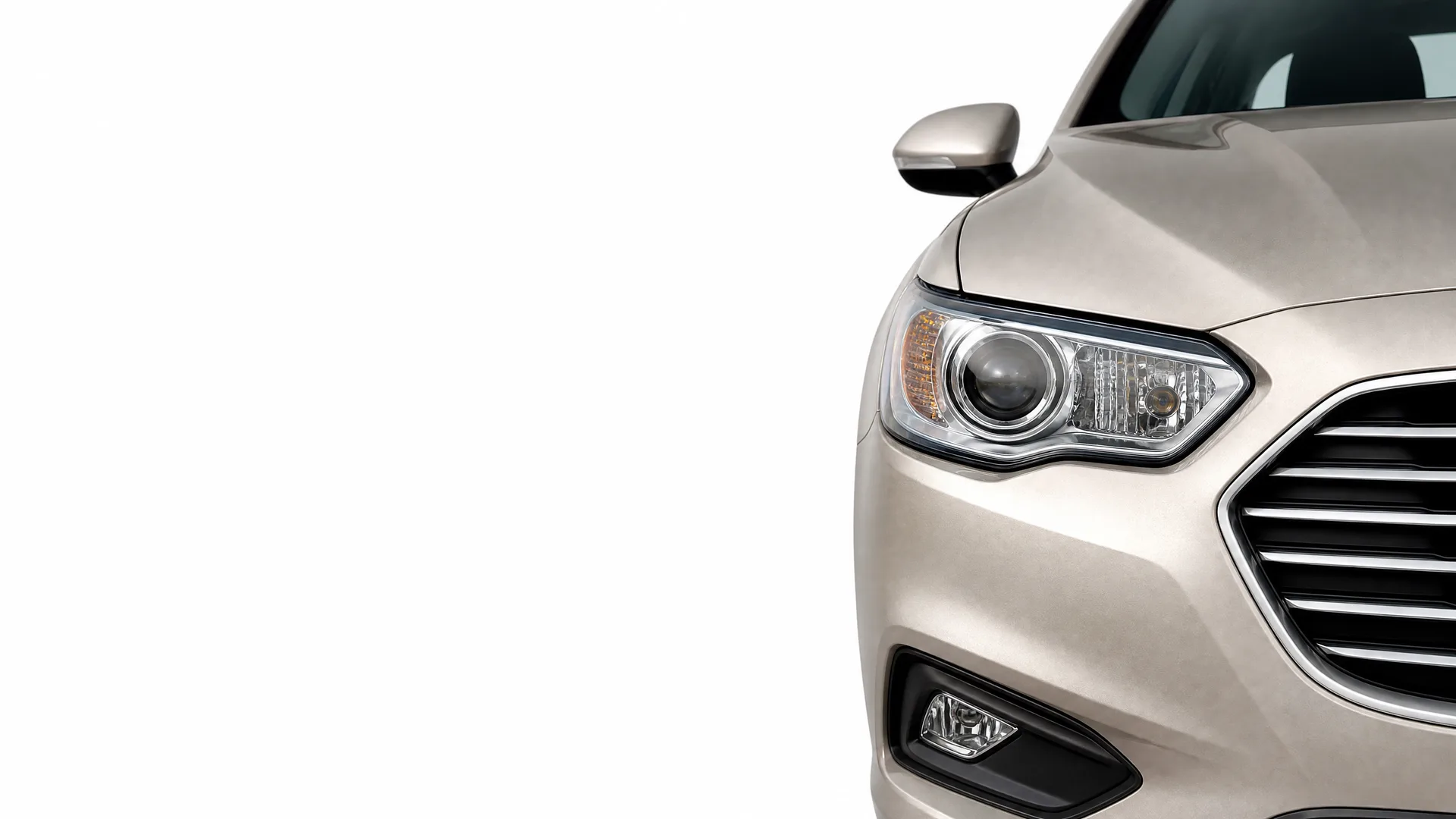 Front right portion of a beige car, showing the headlight, grille, fog light and side mirror, against a plain white background.