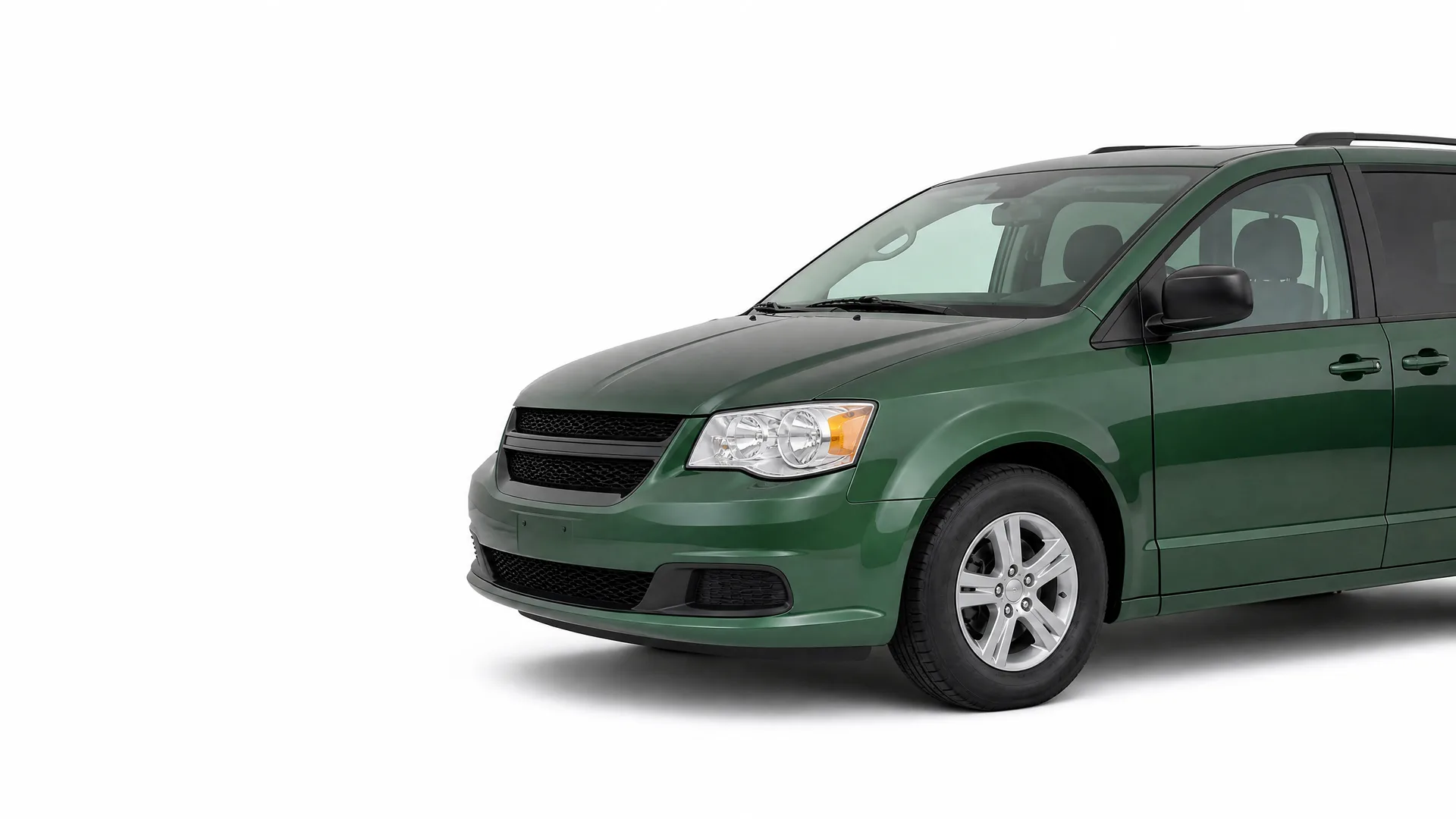 Front three-quarter view of a dark green minivan on a plain white background, cropped so the rear of the vehicle extends past the right edge.