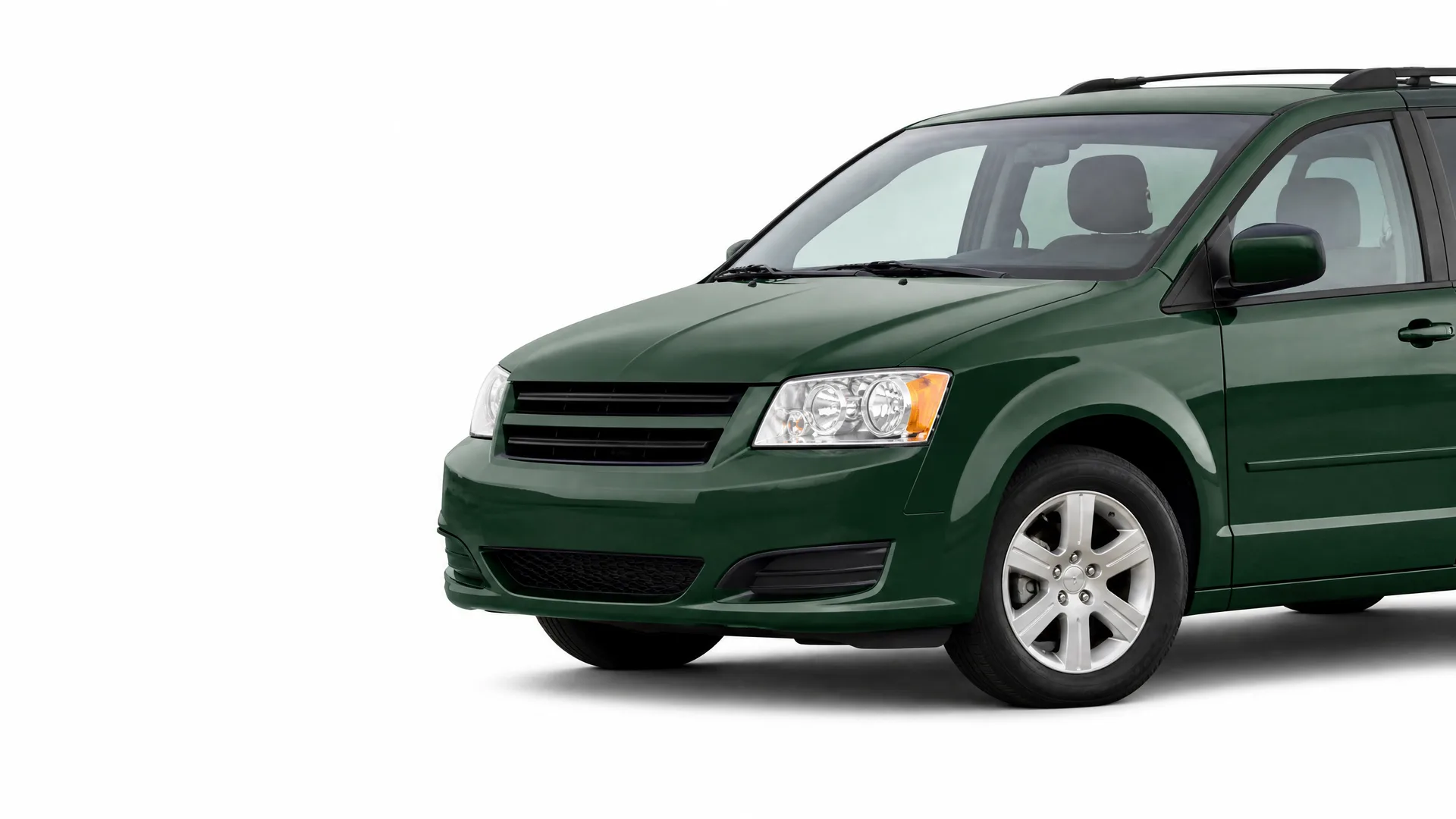 Dark green minivan shown in front three-quarter view against a plain white background, with the rear portion cropped off.