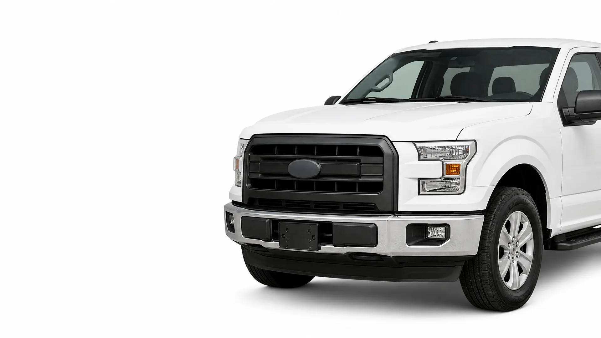 Front three-quarter view of a white pickup truck with a black grille and chrome bumper against a plain white background.