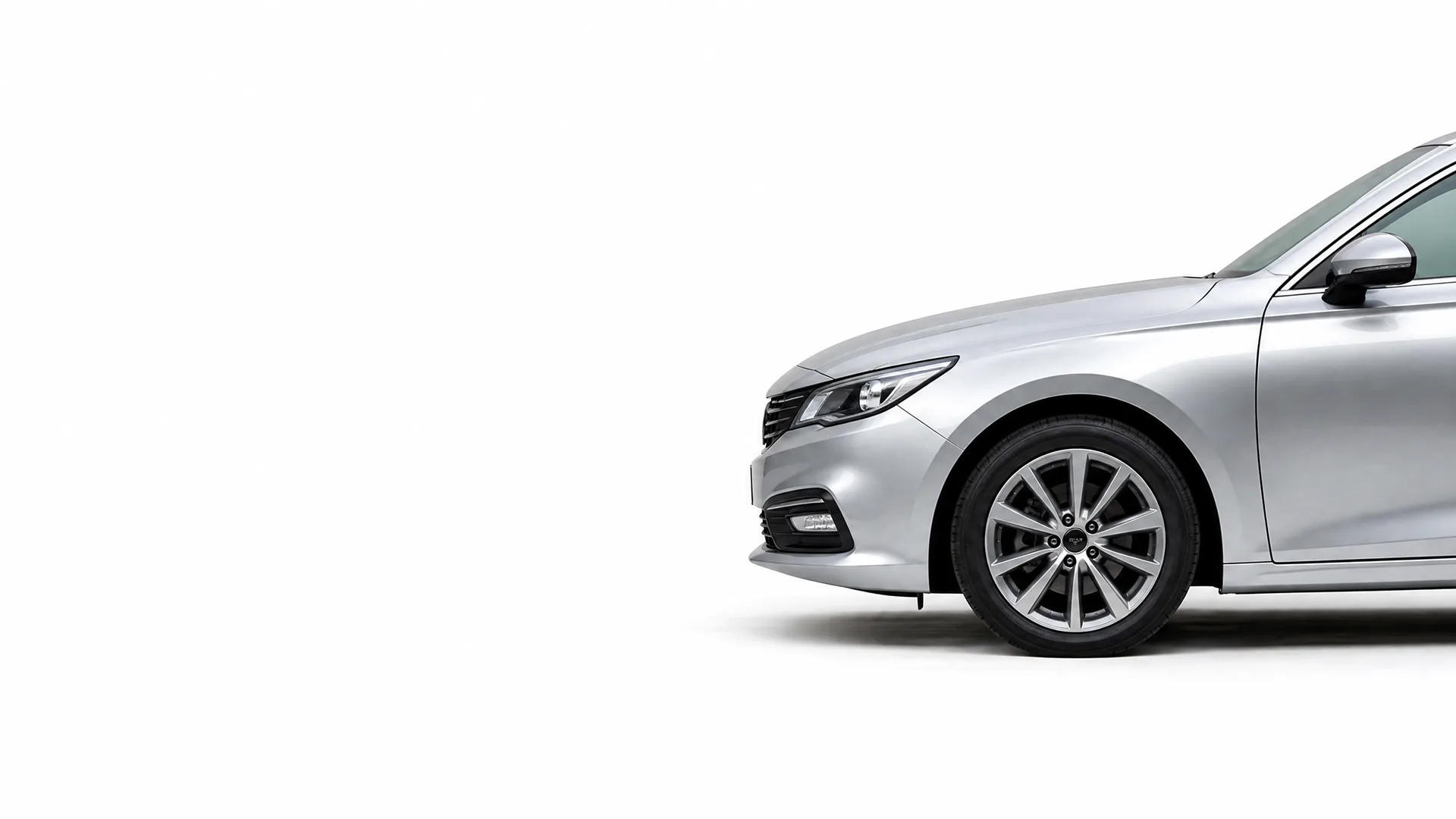 Front half of a silver four-door sedan, shown in profile against a plain white background with a soft shadow beneath.