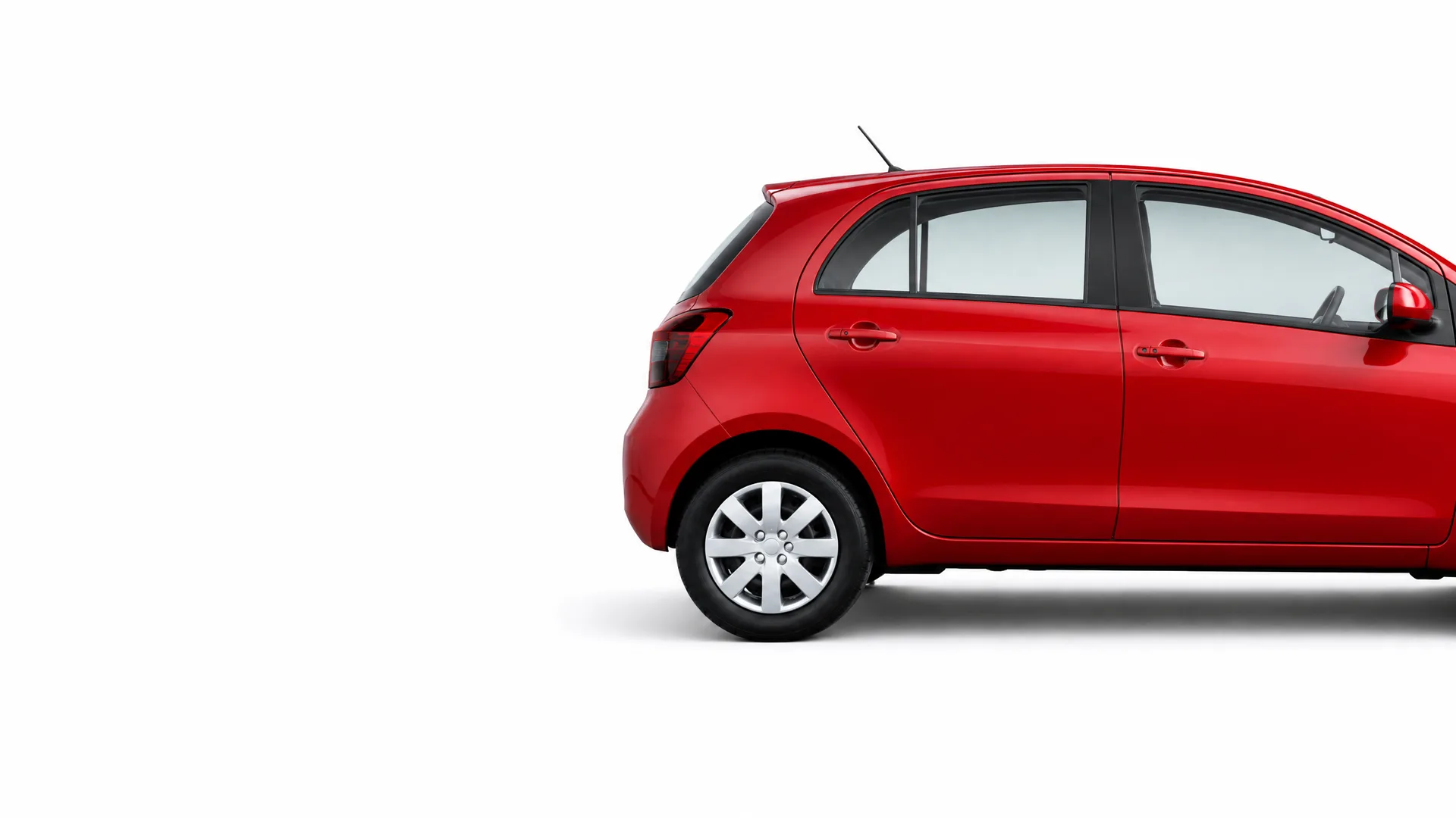 Partial side view of a red five-door hatchback car, showing the rear half, against a plain white background.