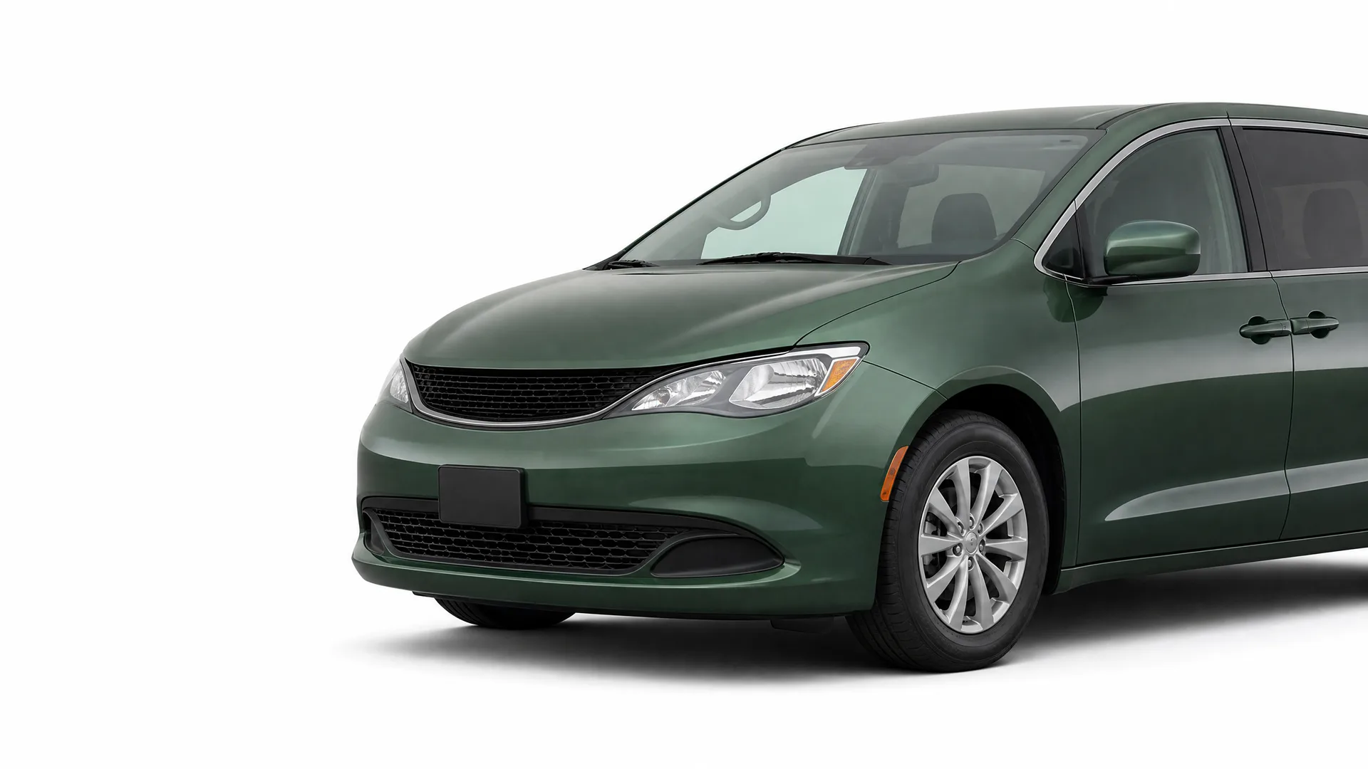 Dark green minivan photographed at a front three-quarter angle against a plain white background.