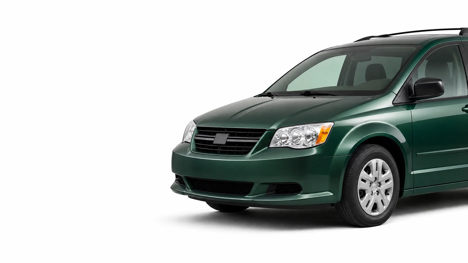 Front three-quarter view of a dark green minivan on a plain white background, with the rear portion cropped out of frame.