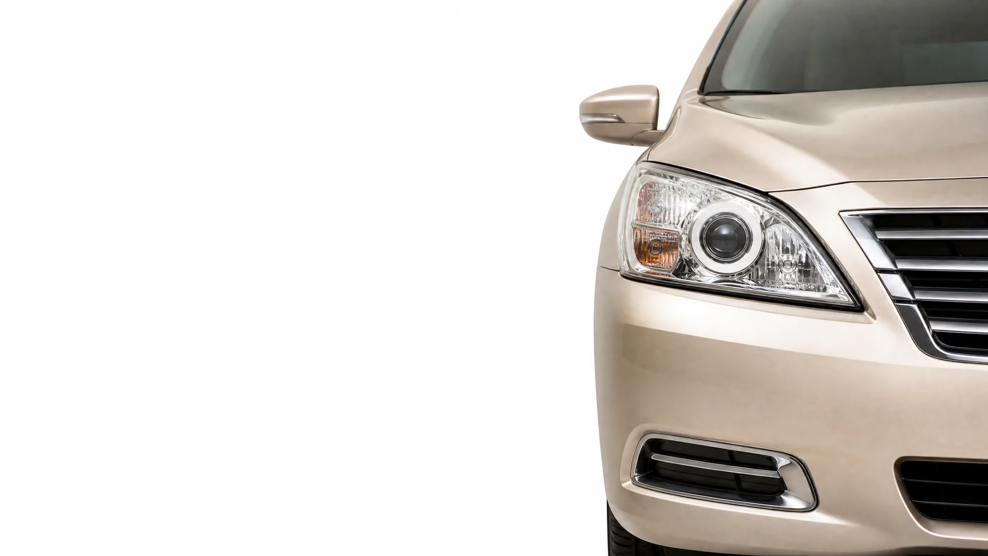 Front right portion of a beige sedan, showing the headlight, grille, side mirror and bumper, against a white background.