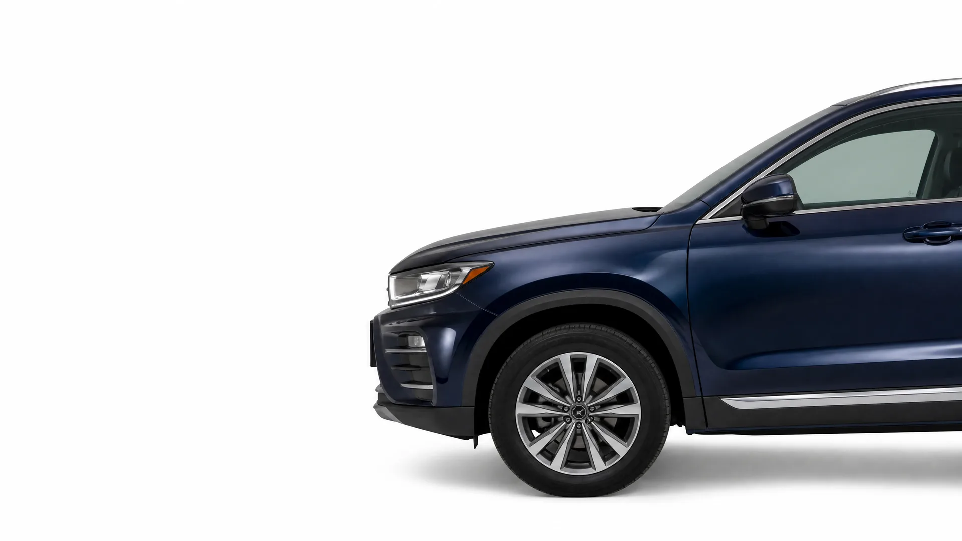 Front half of a dark blue SUV, shown in profile with alloy wheel and side mirror, against a plain white background.