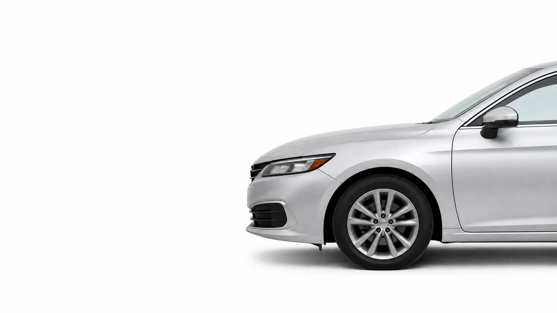 Front half of a silver four-door sedan, shown in profile against a plain white background with the rear portion cropped out of frame.