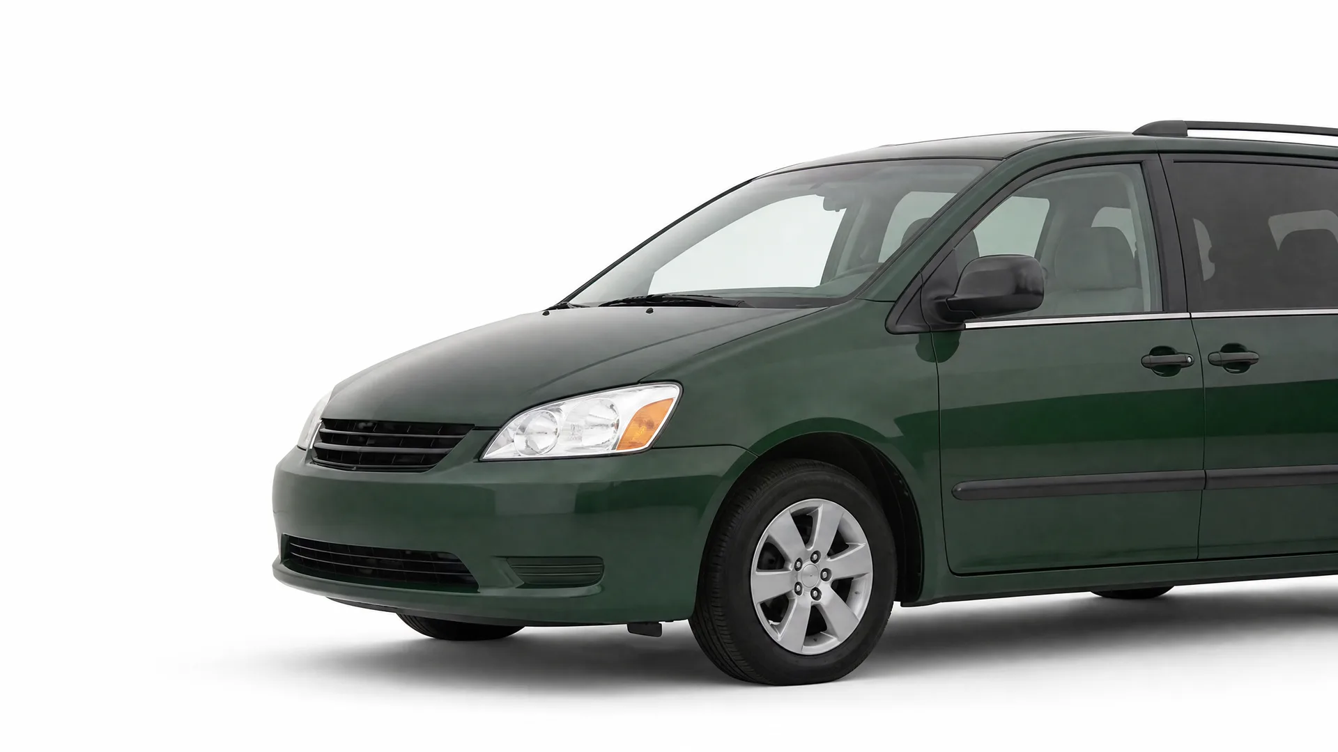 Dark green minivan photographed from the front left against a plain white background, with the rear of the vehicle cropped off.