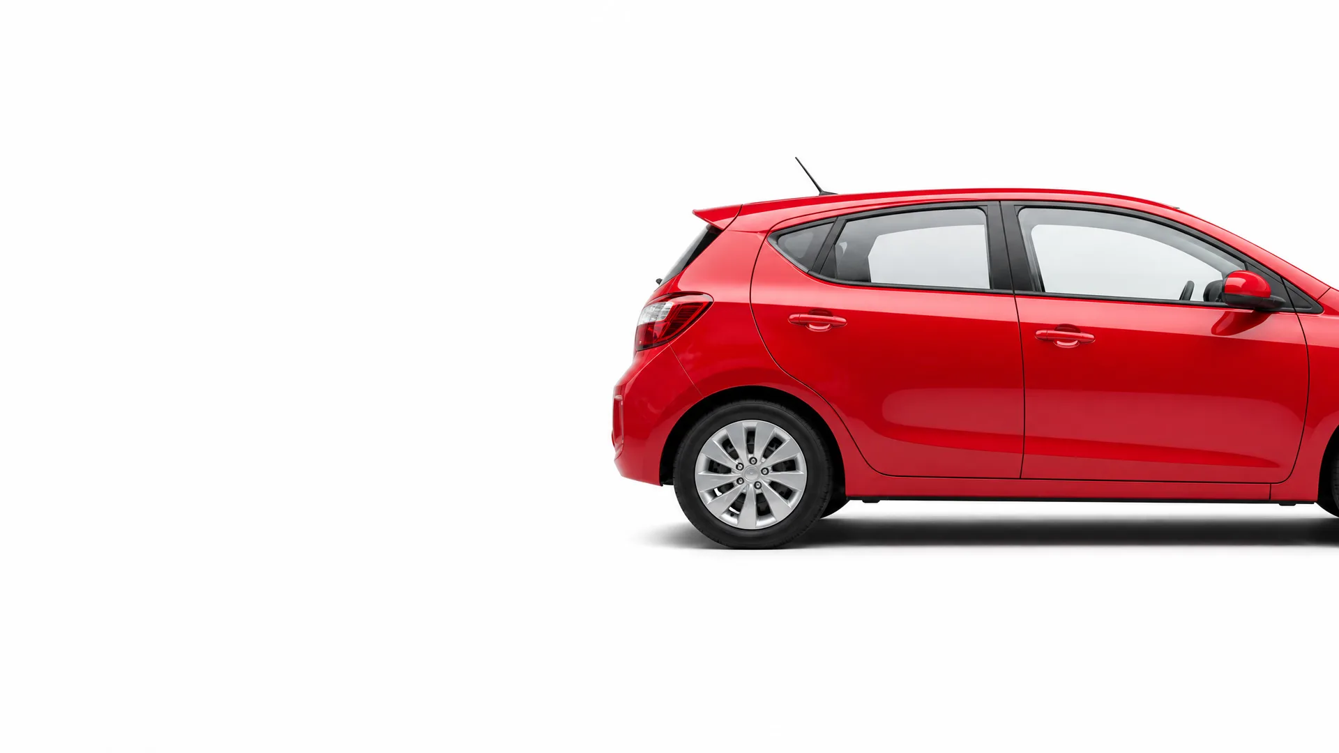 Rear and side view of a red five-door hatchback car, partly cropped at the right edge, against a plain white background.