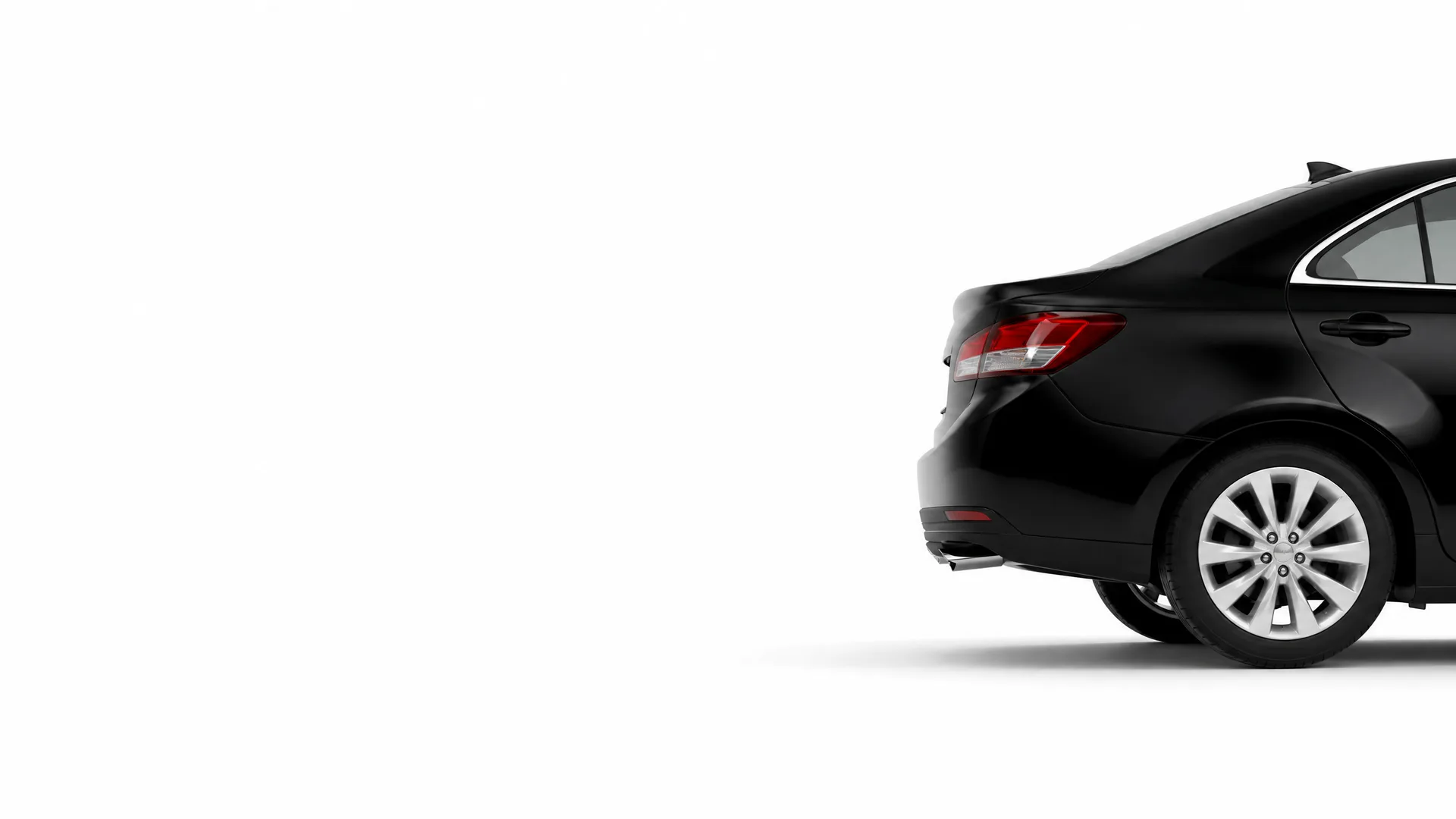 Rear three-quarter view of a black four-door sedan against a plain white background with a soft shadow beneath it.