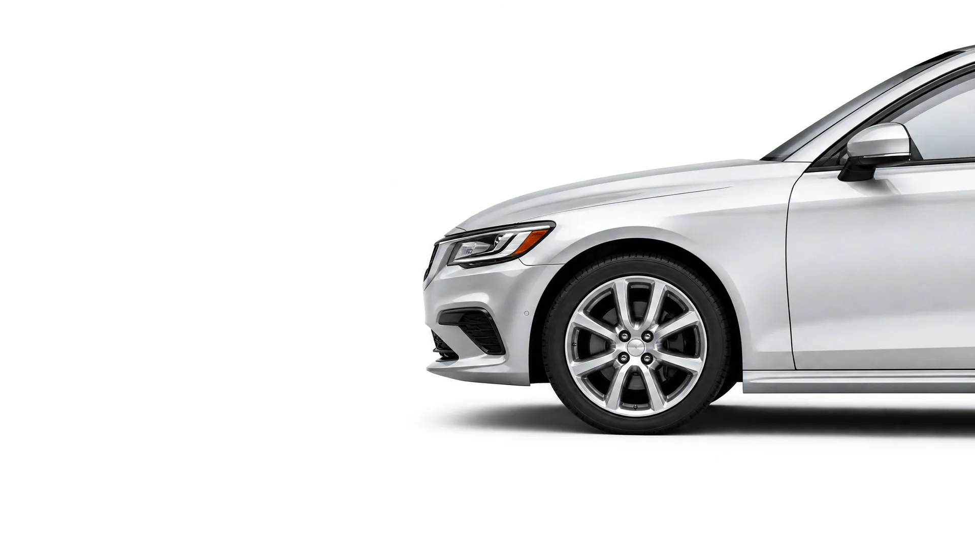 Front half of a silver four-door sedan, shown in profile against a plain white background with a soft shadow beneath.