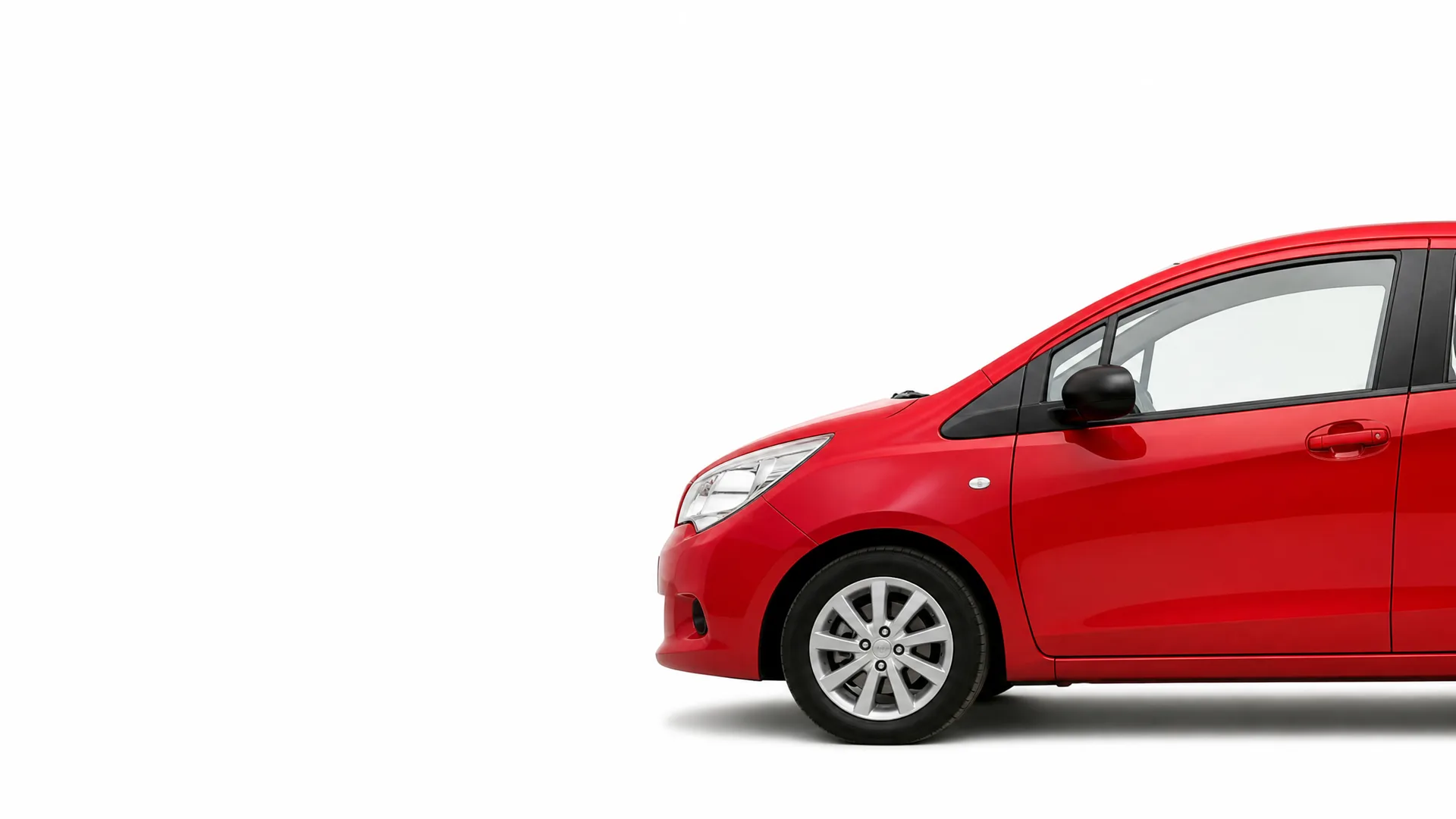 Front half of a red hatchback car shown in side profile against a plain white background, with the rear portion cropped off at the right edge.