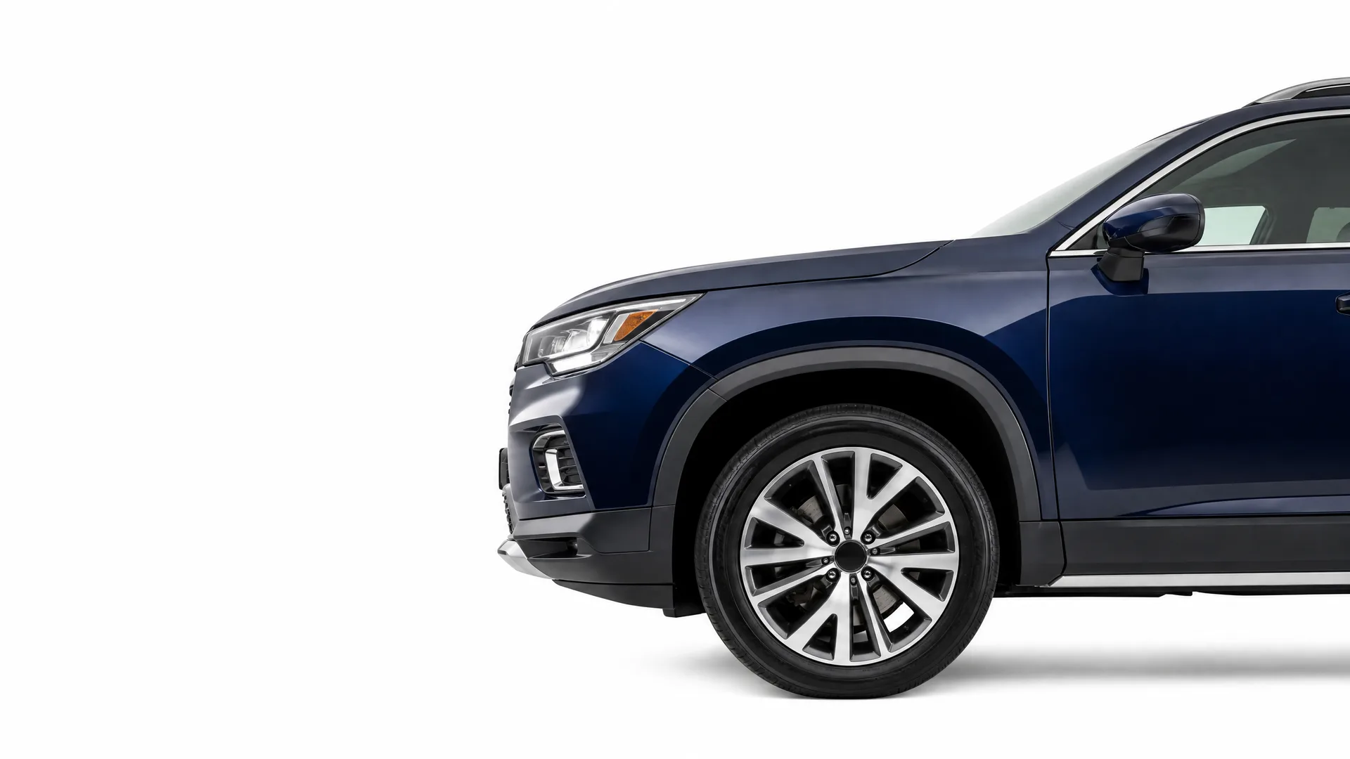 Front half of a dark blue SUV, shown in side profile with alloy wheel and headlight visible, against a plain white background.
