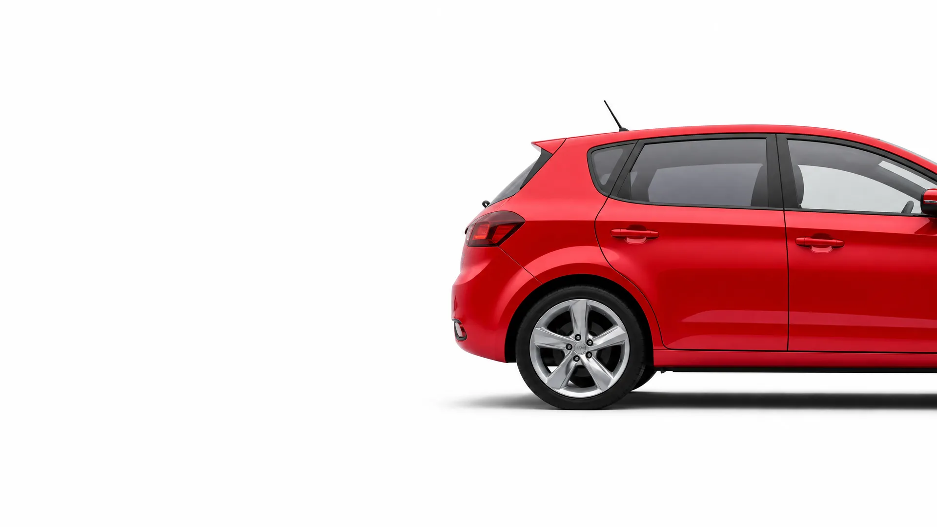 Rear half of a red five-door hatchback car shown in side profile against a plain white background, with the front of the vehicle cropped off at the right edge.