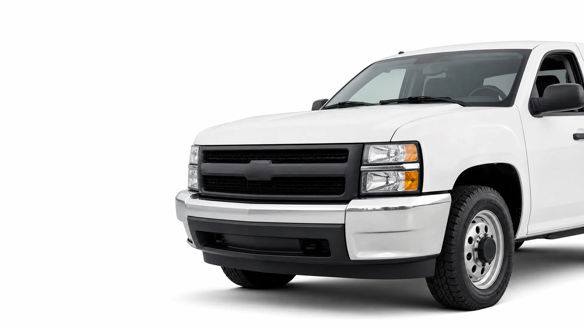 Front three-quarter view of a white pickup truck with a black grille and chrome bumper, isolated on a white background.
