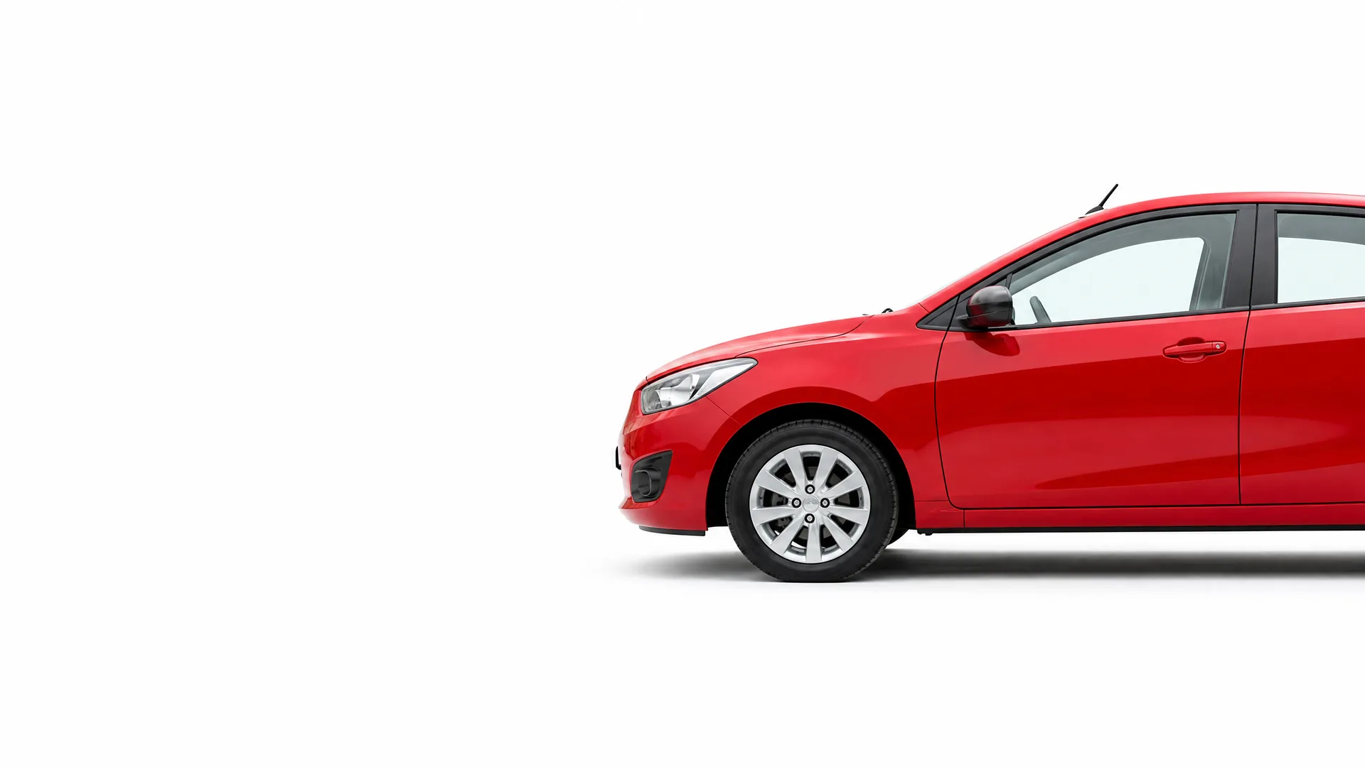 Front portion of a red hatchback car, shown in side profile against a plain white background, with the rear of the vehicle cropped off at the right edge.