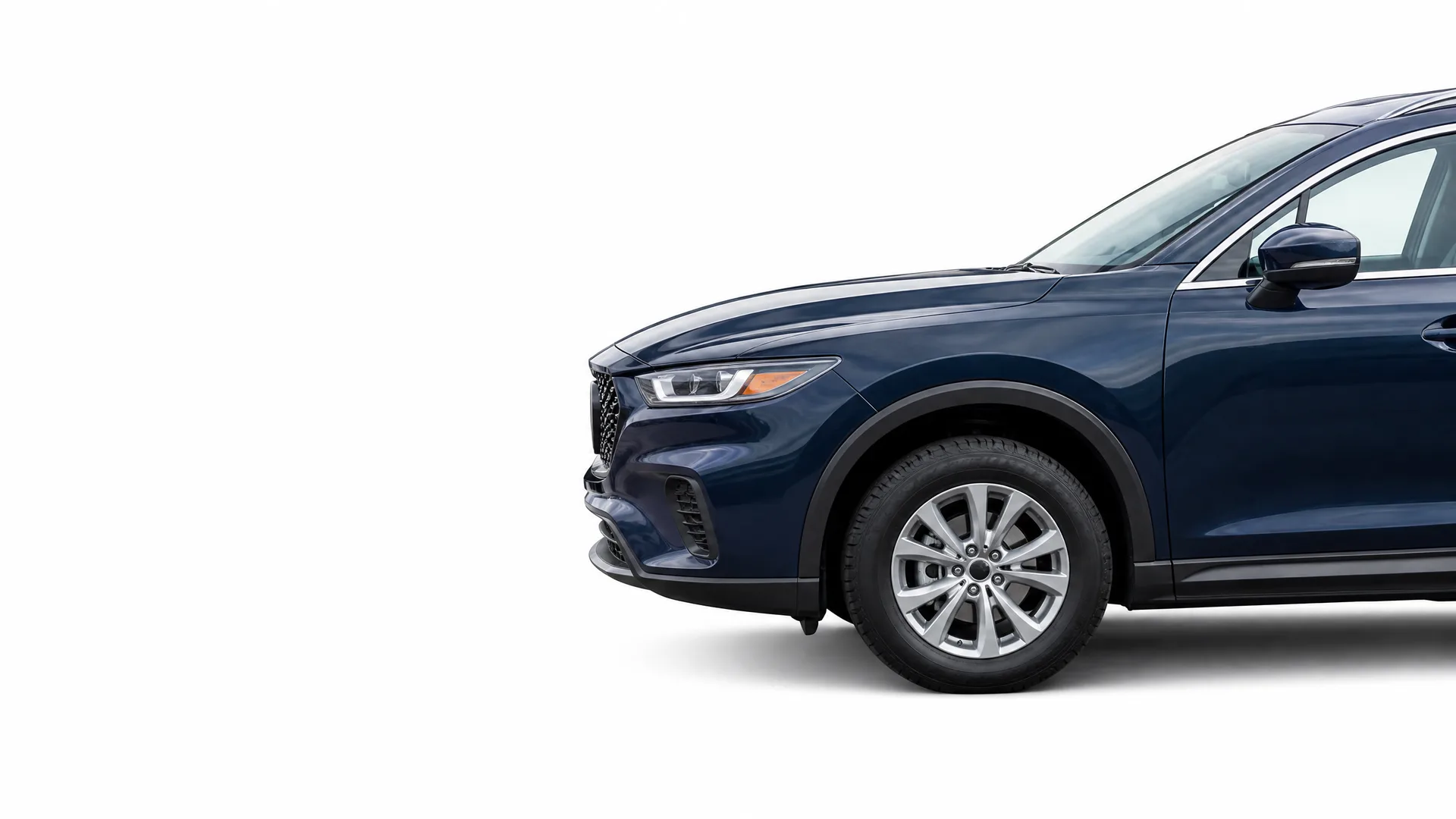 Front half of a dark blue SUV, shown in profile against a plain white background.
