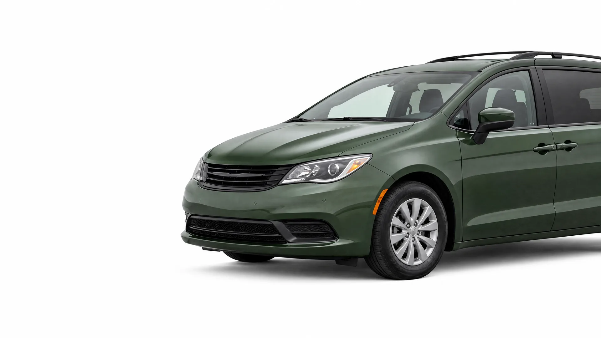 A dark green minivan shown at a front three-quarter angle against a plain white background, with the rear portion cropped off at the right edge.