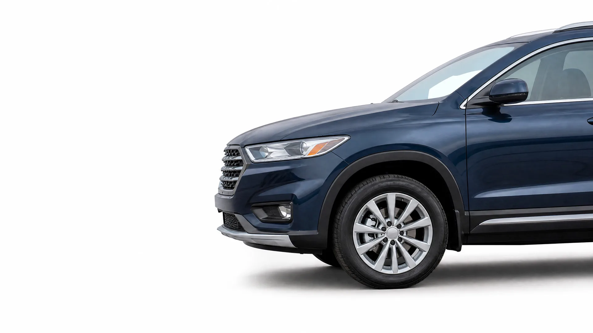 Front half of a dark blue SUV, showing the headlight, grille, front wheel and driver-side door, against a plain white background.