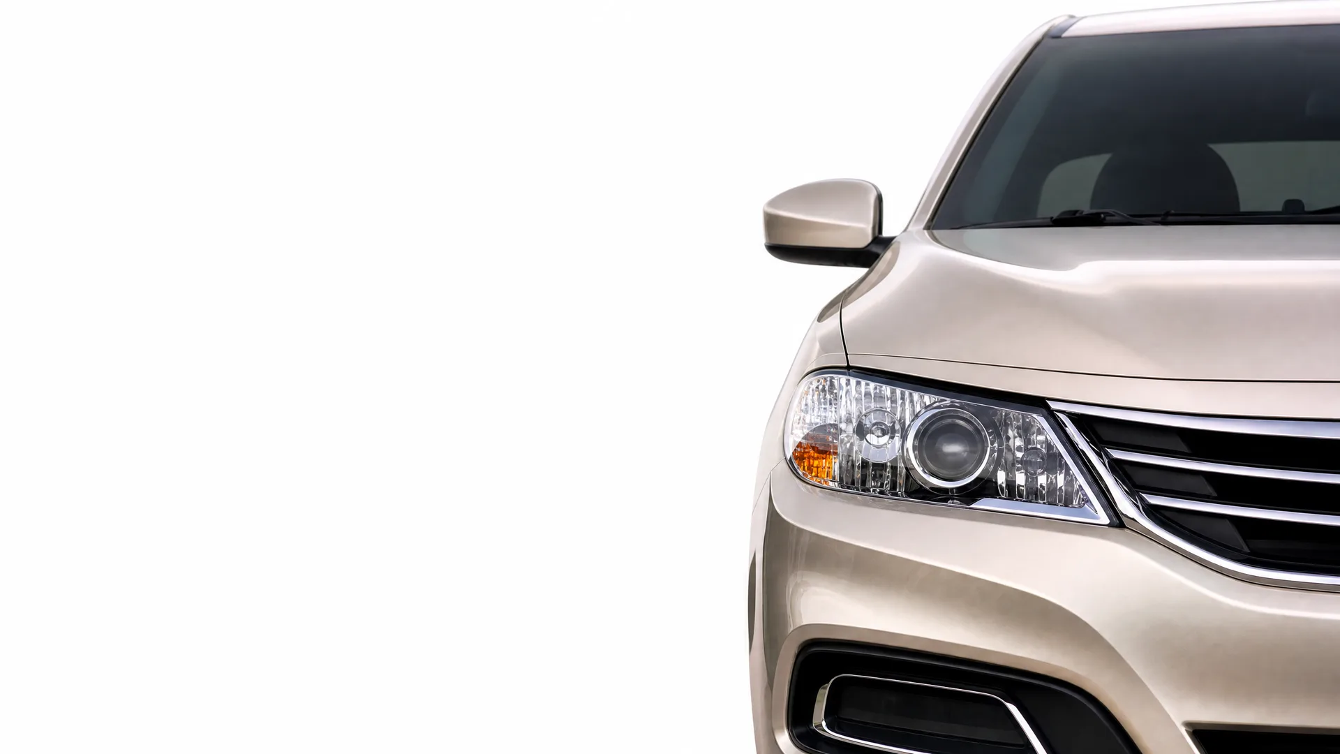 Front left portion of a beige car, showing the headlight, grille, side mirror and windshield, against a plain white background.