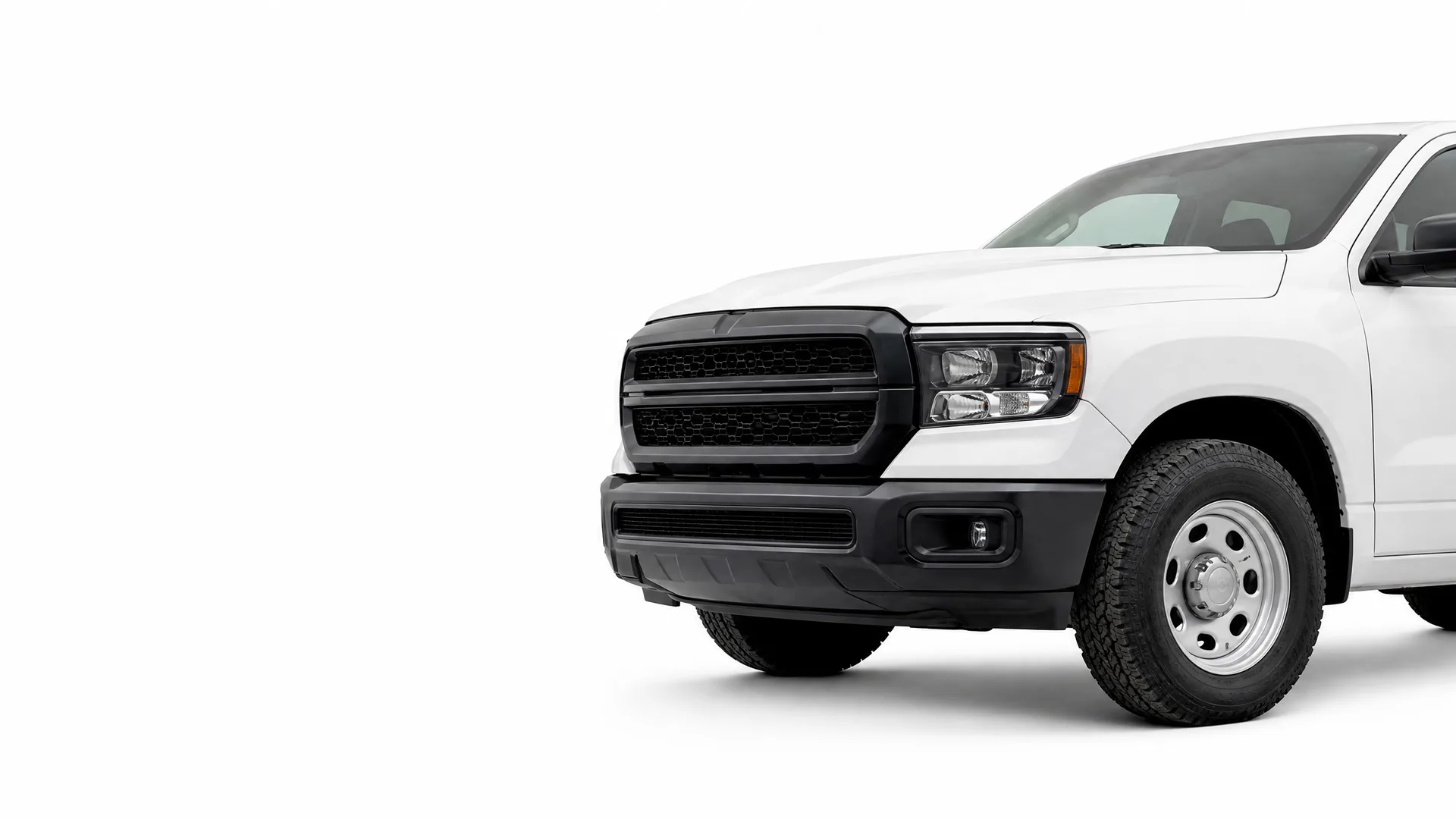 Front half of a white pickup truck with a black grille, black bumper and steel wheels, shown against a plain white background.