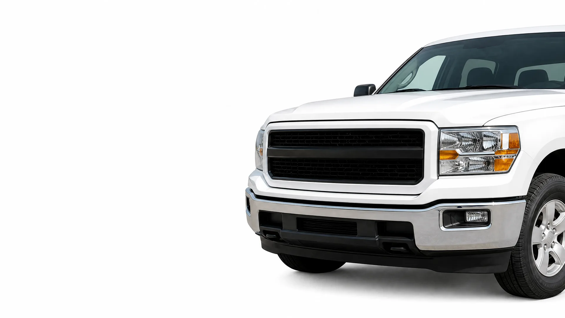Front half of a white pickup truck with a black grille and chrome bumper, shown at an angle against a plain white background.