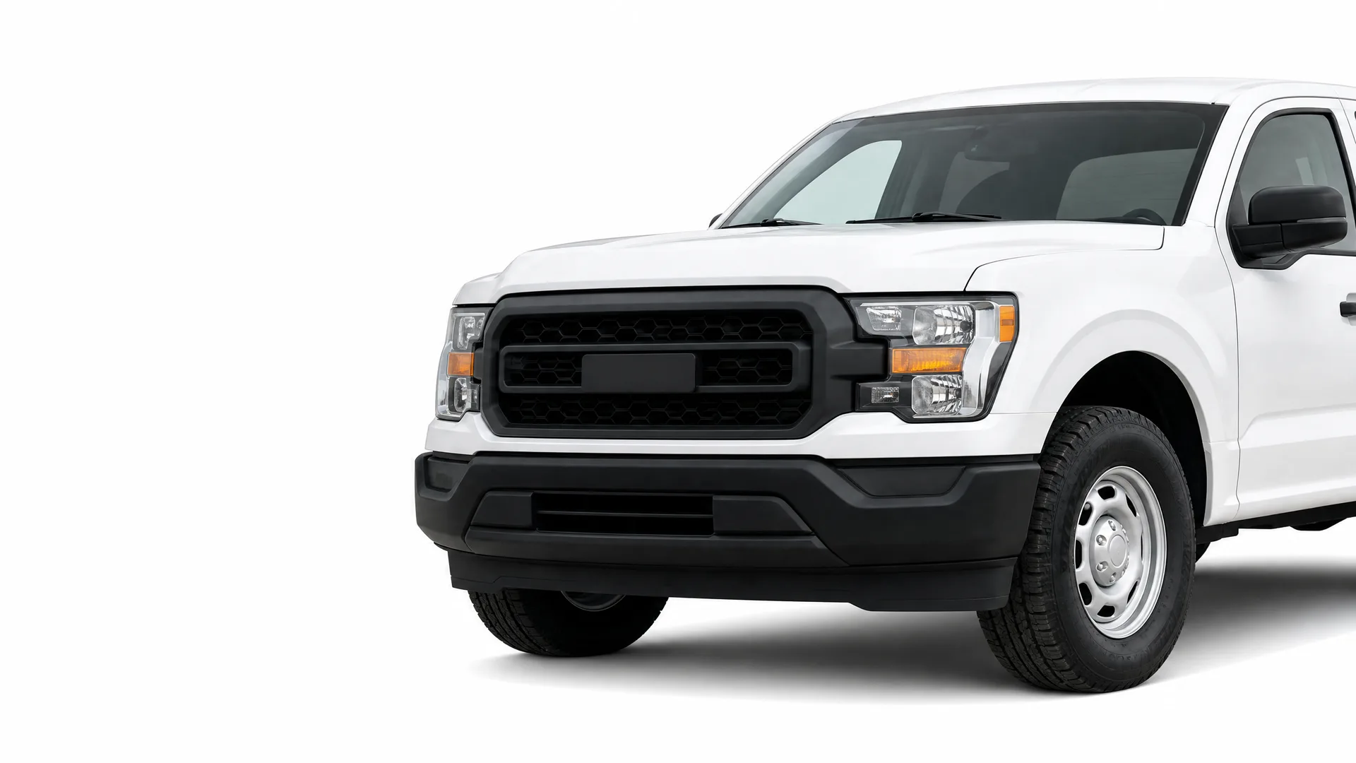 Front three-quarter view of a white extended-cab pickup truck with a black grille, black bumper and steel wheels, photographed against a plain white background.