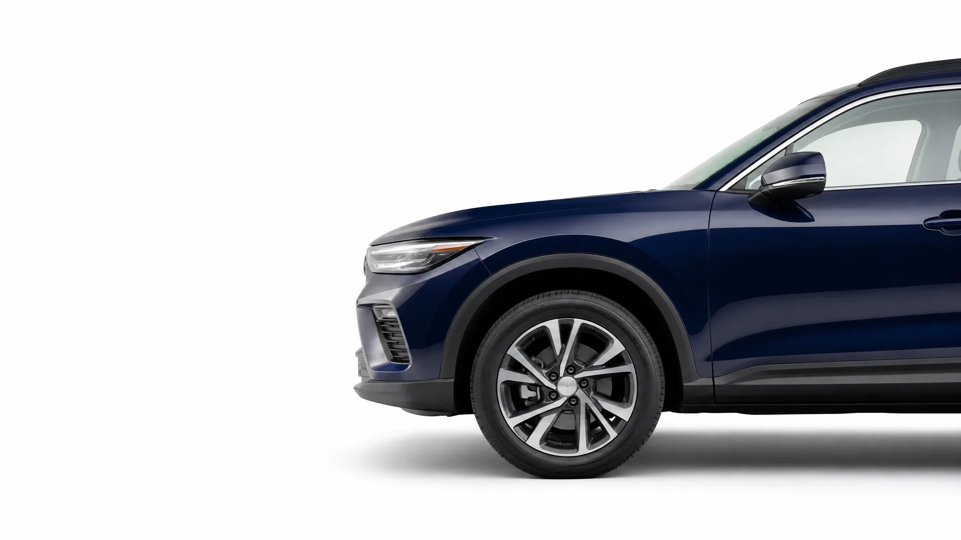 Front portion of a dark blue SUV shown in profile against a plain white background, with the rear of the vehicle cropped out of frame.