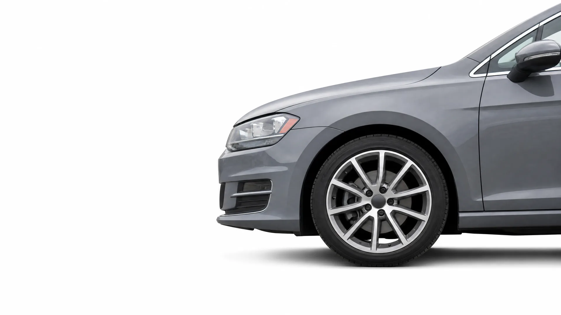 Front portion of a gray hatchback car, showing the front bumper, headlight, wheel and side mirror, isolated on a white background.