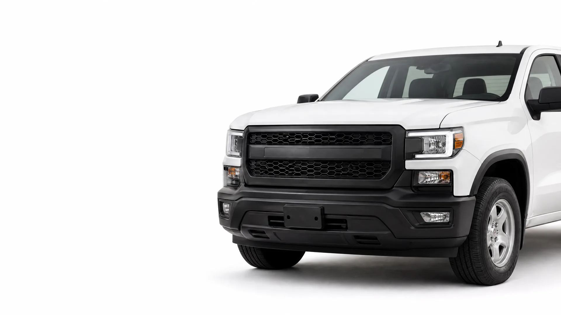 Front three-quarter view of a white pickup truck with a black grille and bumper on a plain white background.