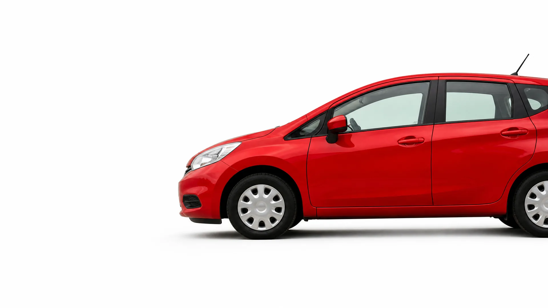 Side view of a red five-door hatchback car, partially cropped at the right edge, on a plain white background.