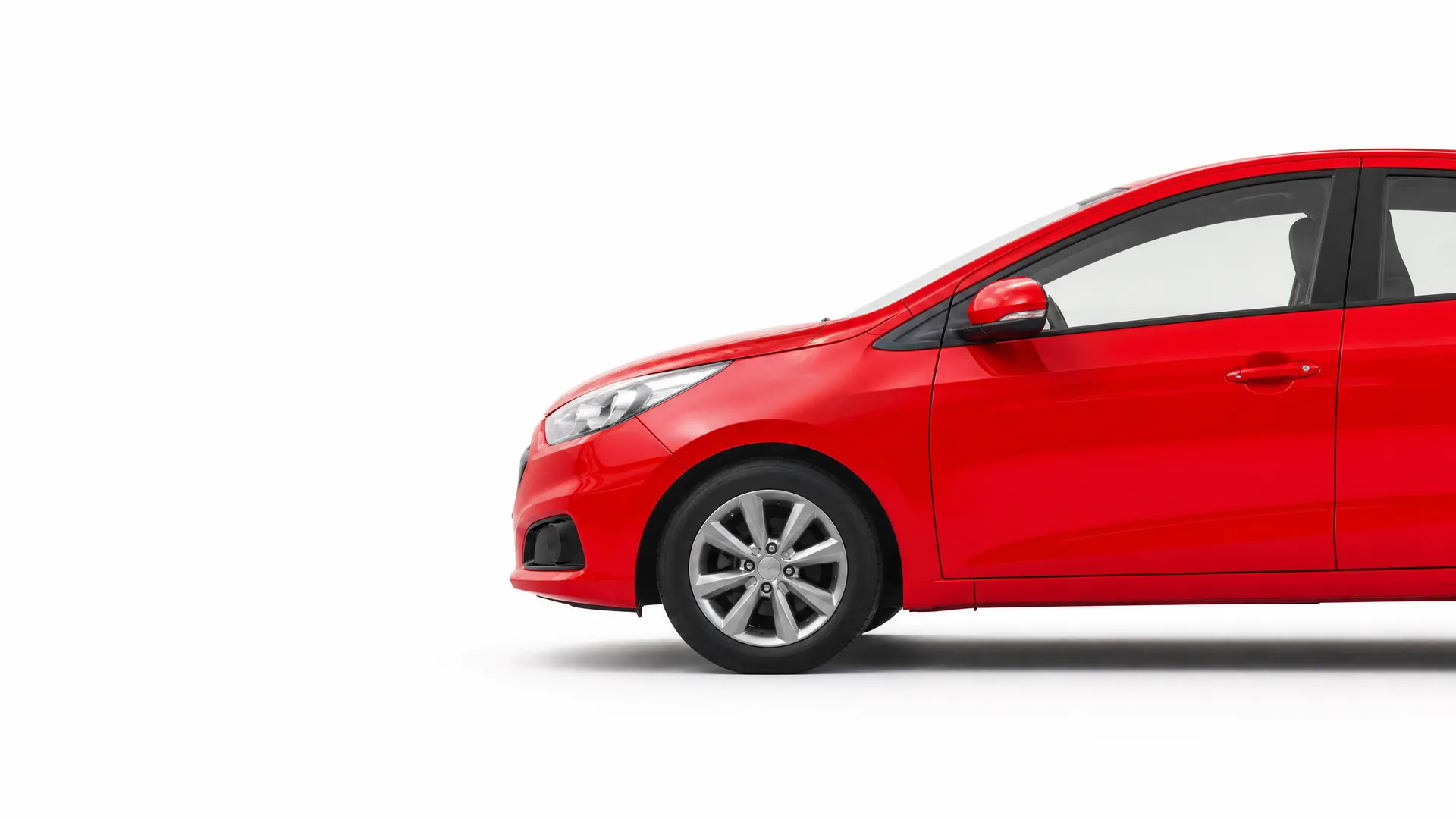 Front half of a red hatchback car shown in profile against a plain white background.