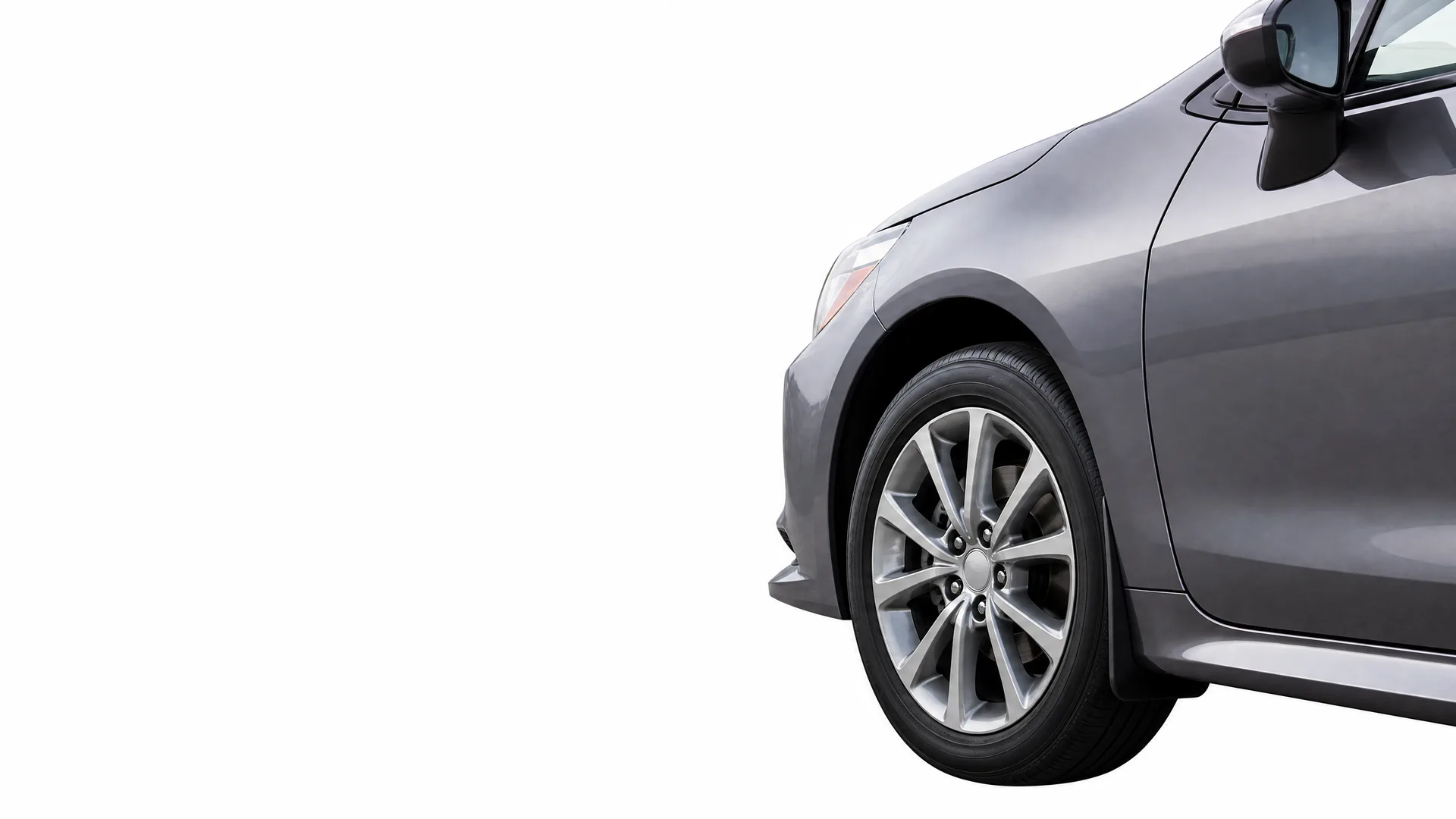 Front side portion of a dark gray car, showing the front wheel with alloy rim, fender, door and side mirror, isolated on a white background.