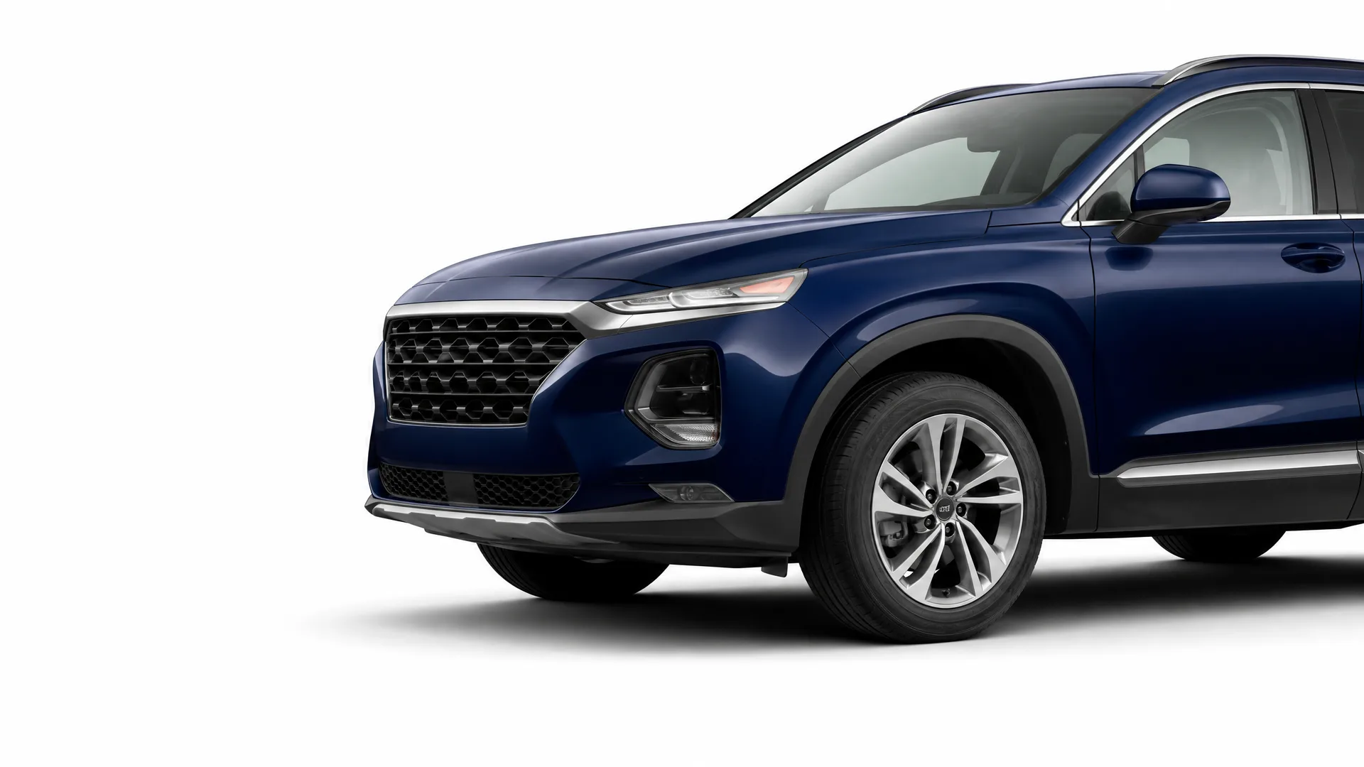 Front three-quarter view of a dark blue SUV with alloy wheels, photographed against a plain white background.