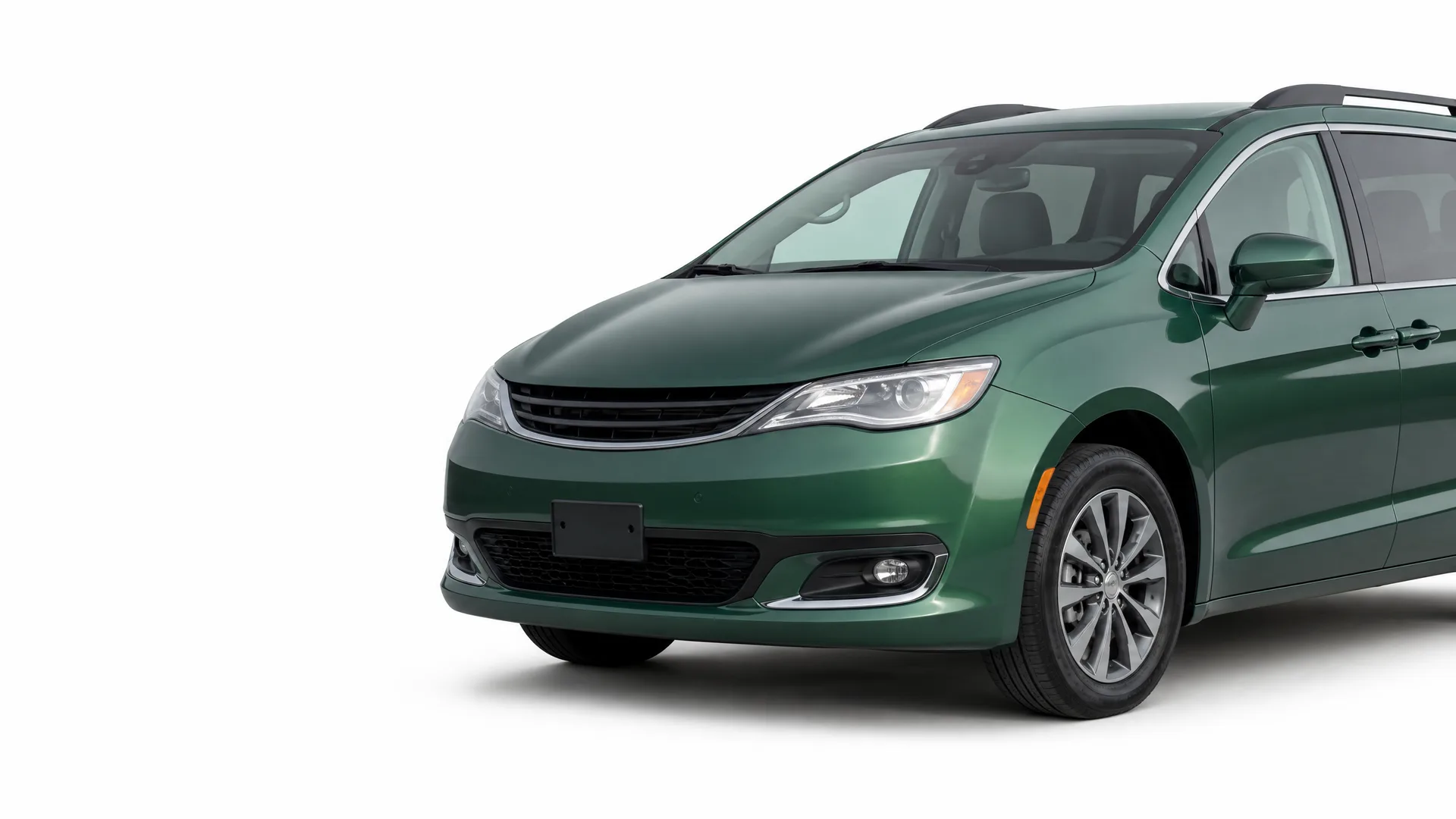 A dark green minivan photographed from the front three-quarter angle against a plain white background.