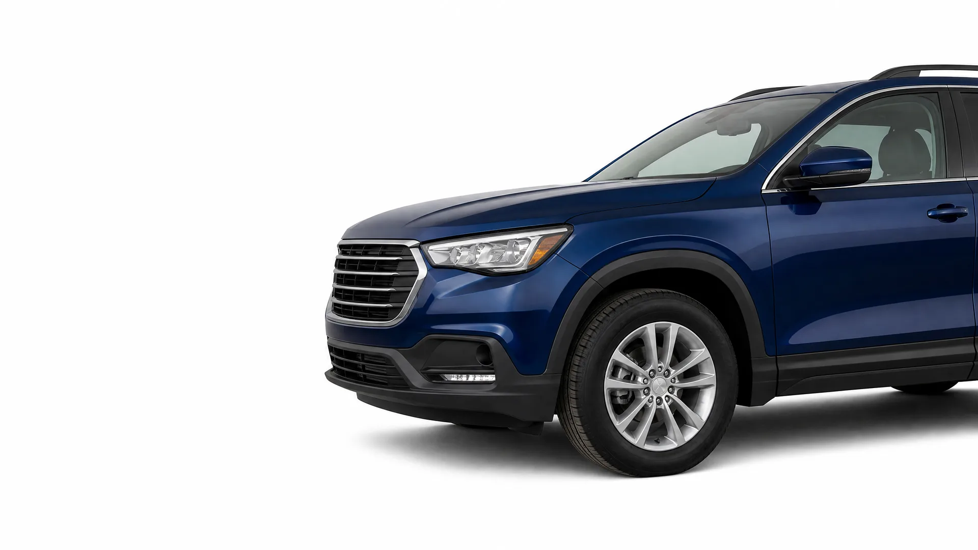 Front three-quarter view of a dark blue SUV, partially cropped at the rear, against a plain white background.