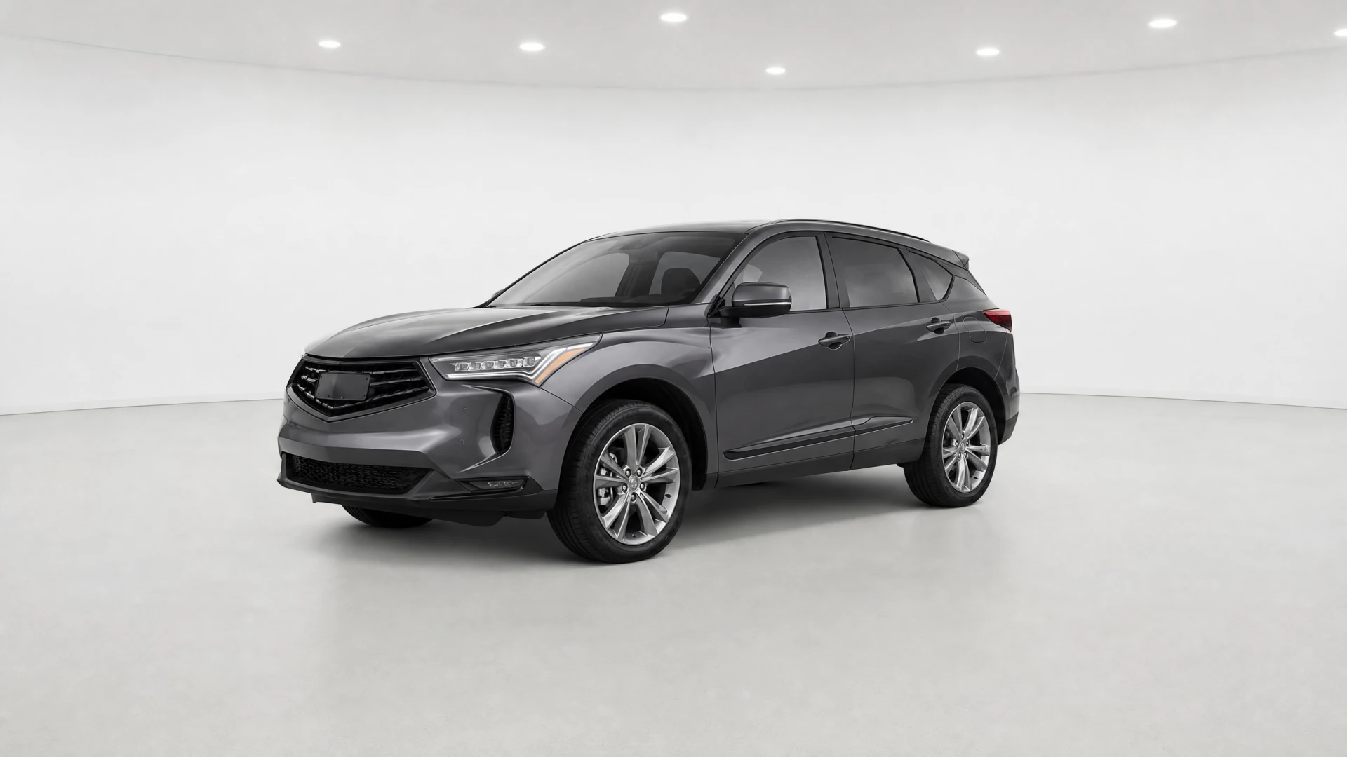 A dark gray compact SUV photographed from a front three-quarter angle in a white studio setting.
