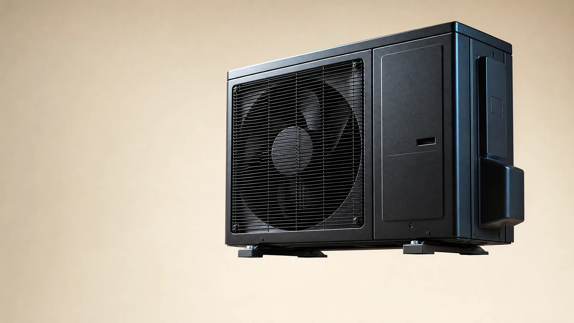 A black outdoor air conditioning condenser unit with a louvered fan grille, shown against a plain beige background.