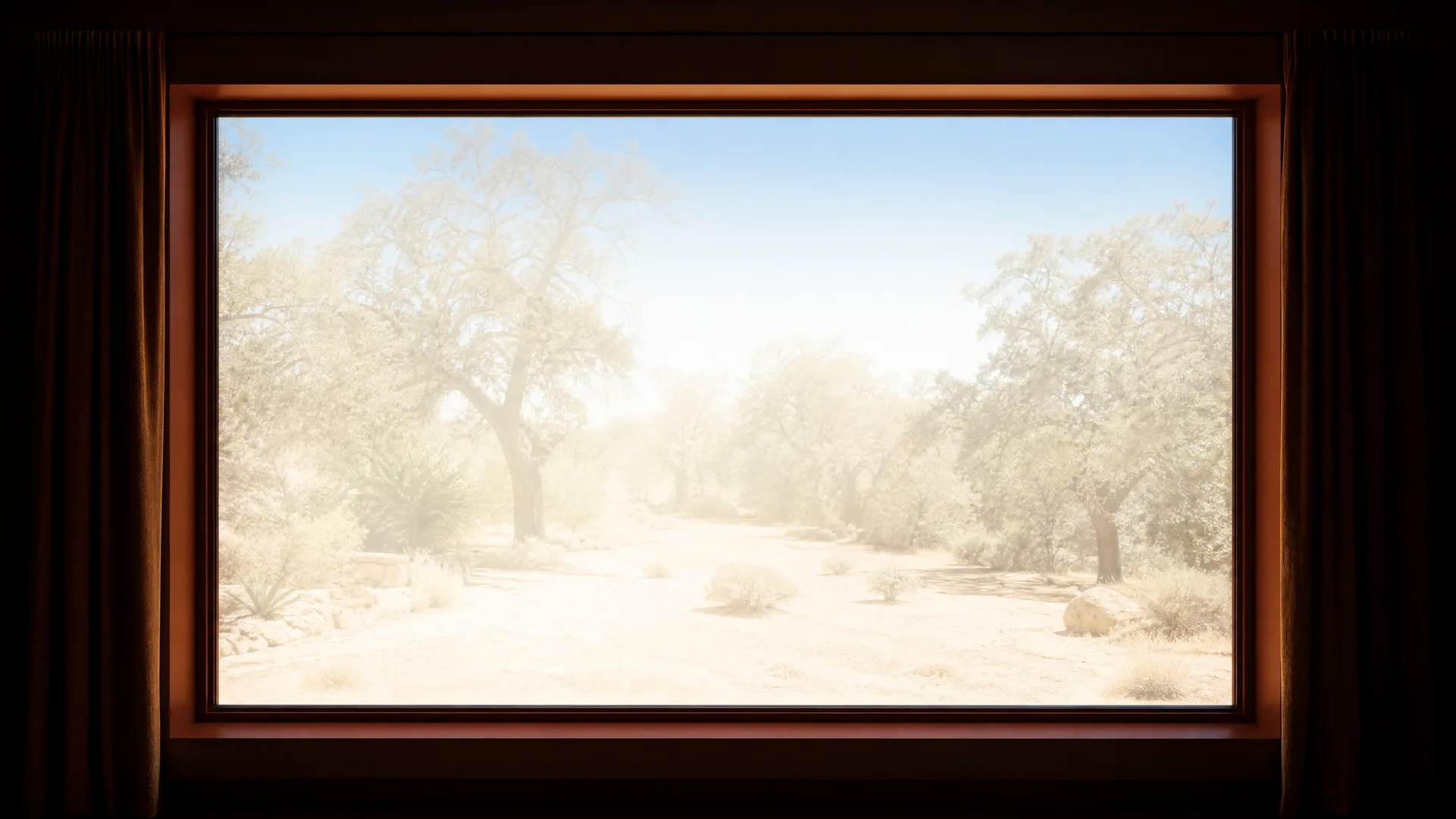 View from a dark interior through a large wood-framed window onto a sunlit, washed-out landscape of pale sandy ground, low shrubs and broad-canopied trees under a clear sky, with dark curtains at both edges.